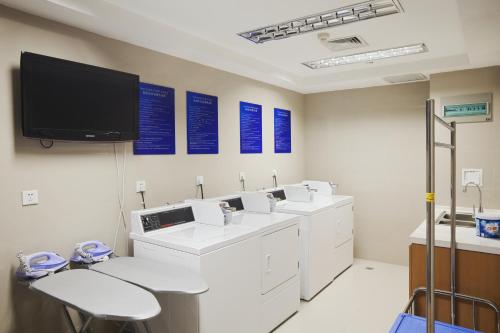 a room with a clinic with a tv on the wall at Holiday Inn Express Suzhou Changjiang by IHG in Suzhou