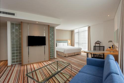 a hotel room with a bed and a tv at Holiday Inn Express Shanghai Jiading Industry Park by IHG in Jiading