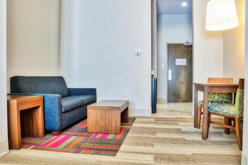 a living room with a couch and a table at Holiday Inn Express Slidell by IHG in Slidell