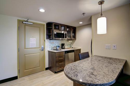 a kitchen with a table and a counter top at Candlewood Suites Richmond - West Broad by IHG in Richmond