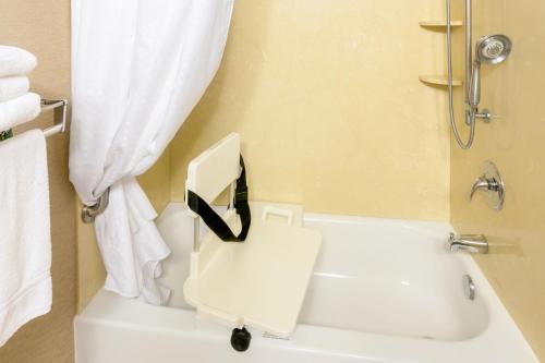 a bathroom with a white toilet and a shower at Holiday Inn Express Roseburg by IHG in Roseburg