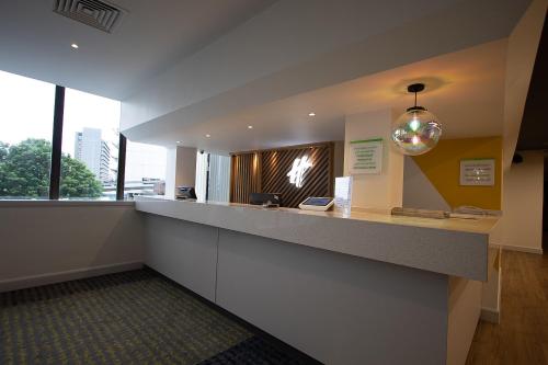 
a bathroom with two sinks and a large mirror at Holiday Inn Preston, an IHG Hotel in Preston
