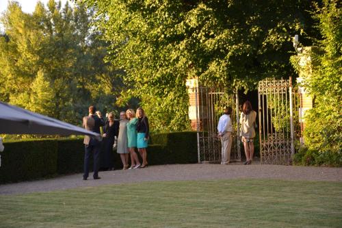a group of people standing in front of a fence at Château De Pray in Amboise