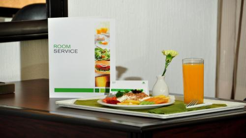 a plate of food on a table with a glass of orange juice at Holiday Inn Tijuana Zona Rio by IHG in Tijuana