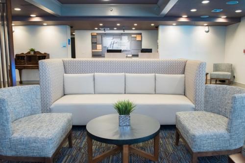 a living room with a couch and two chairs and a table at Holiday Inn Express Pascagoula-Moss Point by IHG in Moss Point