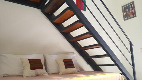 a couch with pillows sitting under a stair case at Loft Andino I - Comfort moderno a 5' del centro in Salta