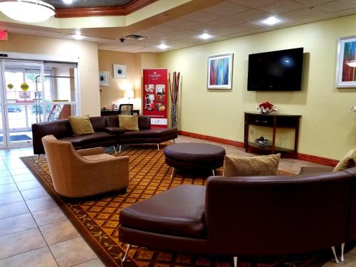 a living room filled with furniture and a tv at Candlewood Suites San Antonio Downtown, an IHG Hotel in San Antonio