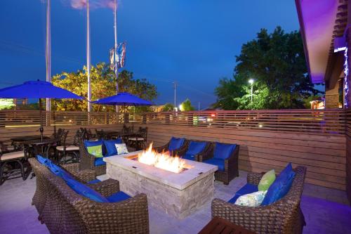 a fire pit on a patio with chairs and tables at Holiday Inn Express Hotel & Suites - Paso Robles, an IHG Hotel in Paso Robles