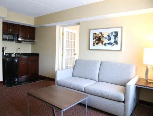 a living room with a couch and a table at Holiday Inn Salem by IHG in Salem