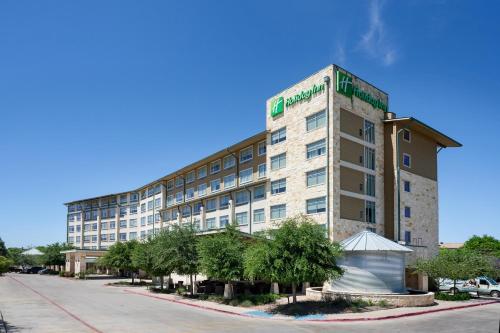 a large building on the side of a street at Holiday Inn San Antonio Northwest- SeaWorld Area by IHG in San Antonio