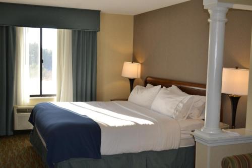 a hotel room with a large bed with two lamps at Holiday Inn Express Hotels Biddeford by IHG in Biddeford