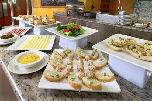 a buffet with several plates of food with appetizers at Holiday Inn Tampico-Altamira by IHG in Tampico