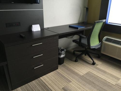 an office with a desk with a chair and a computer at Holiday Inn Express & Suites Oswego by IHG in Oswego