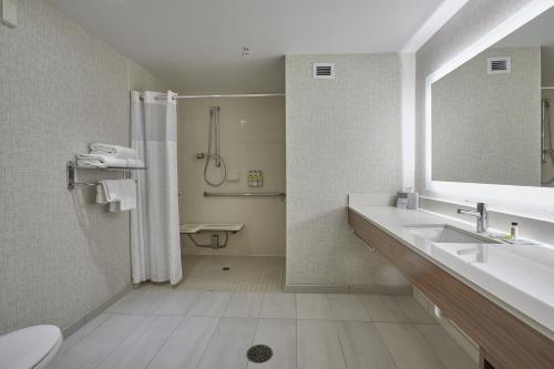 a bathroom with a sink and a shower and a toilet at Holiday Inn Express : Eugene - Springfield by IHG in Springfield