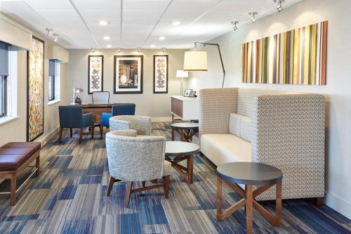 a waiting room with chairs and a couch and tables at Holiday Inn Express Sheboygan-Kohler / I-43, an IHG Hotel in Sheboygan