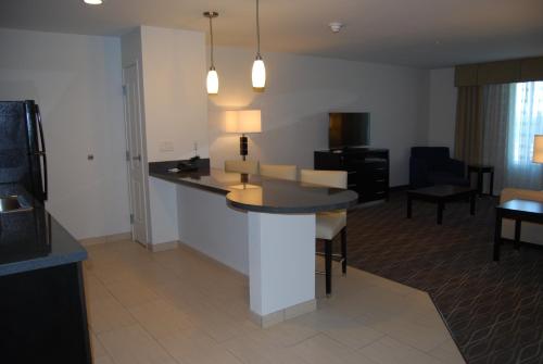 a kitchen and living room with a table and chairs at Holiday Inn Express & Suites Springville-South Provo Area by IHG in Springville