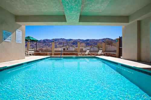 a swimming pool with a view of the mountains at Holiday Inn Express Hotel & Suites Twentynine Palms, an IHG Hotel in Twentynine Palms