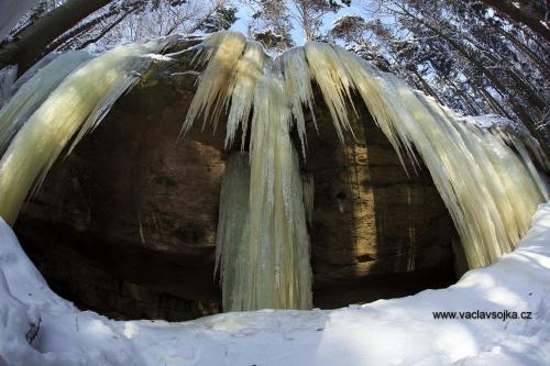 a waterfall in the snow with ice on it at Penzion Kamzík in Česká Kamenice