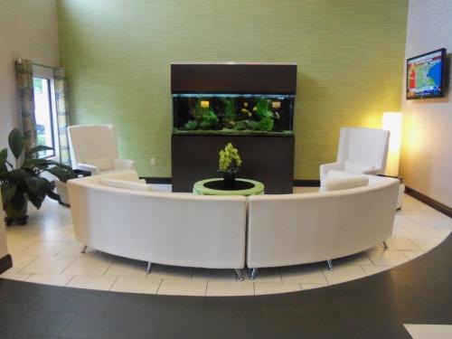 a lobby with a large couch and an aquarium at Holiday Inn Express Hotel & Suites Sanford by IHG in Sanford