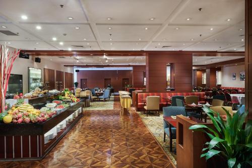 a hotel lobby with a buffet of food and tables at Holiday Inn Temple Of Heaven Beijing by IHG in Beijing