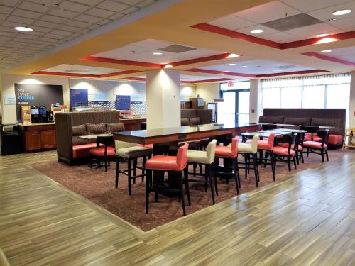 a lobby with a bar with chairs and tables at Holiday Inn Express Portland West/Hillsboro by IHG in Hillsboro
