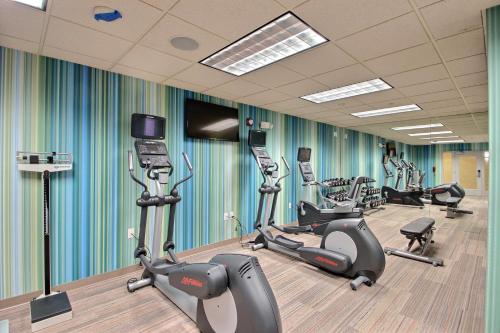 a gym with several treadmills and cardio machines at Holiday Inn Express Hotel & Suites Milwaukee Airport by IHG in Milwaukee