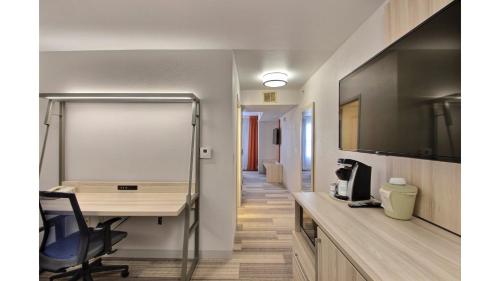 a office with a desk and a computer in a room at Holiday Inn Express Hotel & Suites Milwaukee Airport by IHG in Milwaukee