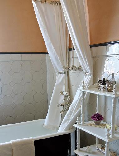 a bath tub with a curtain in a bathroom at Casa Briga in Montesilvano