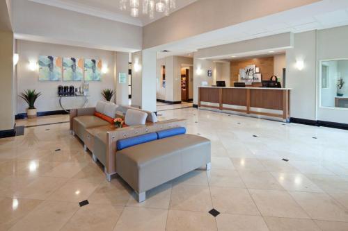 a lobby of a hospital with a couch in the middle at Holiday Inn Palmdale-Lancaster by IHG in Palmdale