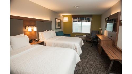 a hotel room with two beds and a television at Holiday Inn Express Hotel & Suites Norfolk by IHG in Norfolk