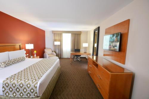 a hotel room with a bed and a desk at Crowne Plaza Monterrey Aeropuerto by IHG in Monterrey
