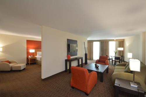 a hotel room with a living room and a hotel suite at Crowne Plaza Monterrey Aeropuerto by IHG in Monterrey