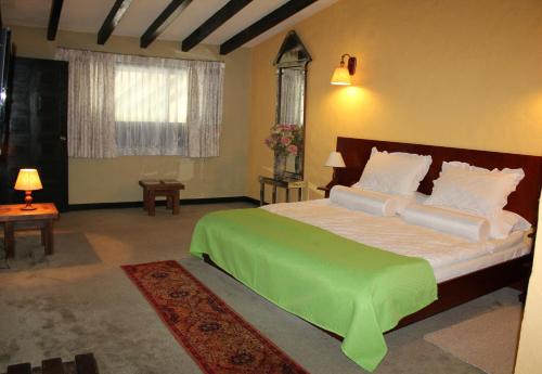 מיטה או מיטות בחדר ב-HH HACIENDA EL CARMEN CENTRO DE CONVENCIONES