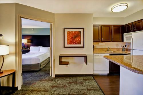 A bed or beds in a room at Staybridge Suites Madison - East, an IHG Hotel