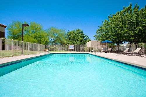 a swimming pool with blue water in a yard at Holiday Inn Express Scottsdale North by IHG in Scottsdale
