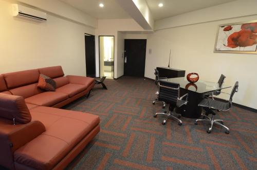 a living room with a couch and a table at Holiday Inn Mexico Dali Airport by IHG in Mexico City