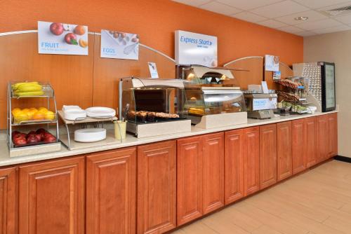 a kitchen with wooden cabinets and a counter with food at Best Western North Attleboro - Providence Beltway in North Attleboro