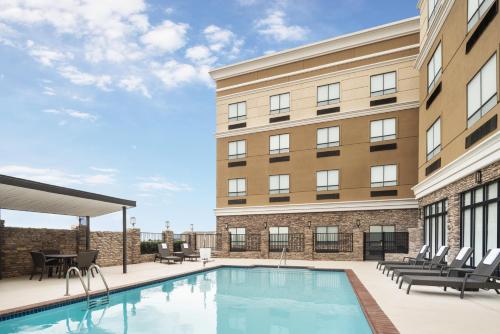a swimming pool in front of a building at Holiday Inn Odessa by IHG in Odessa