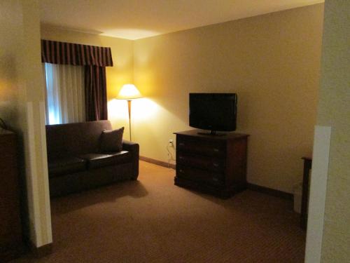 a living room with a couch and a television at Wingate by Wyndham Newell in Newell