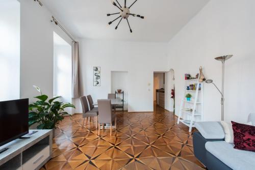 a living room with a couch and a dining room at Belvedere Central Apartment in Vienna