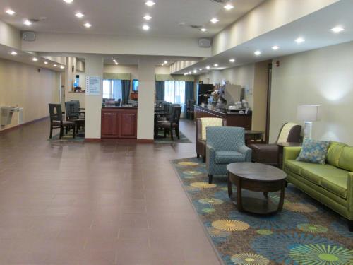 a lobby with couches and chairs and a table at Wingate by Wyndham Newell in Newell
