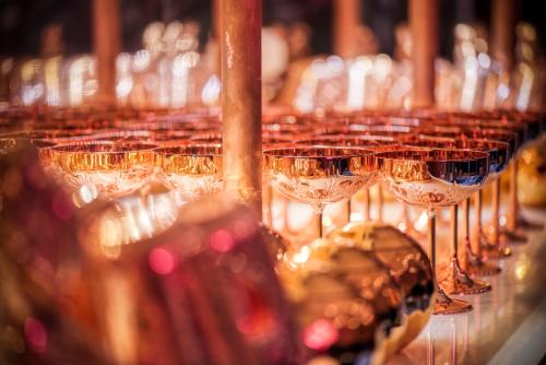 a row of wine glasses on a table at Wi-Ki-Woo Boutique Hotel in San Antonio