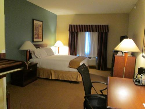 a hotel room with a bed and a desk at Wingate by Wyndham Newell in Newell