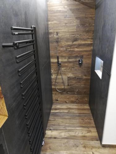 a bathroom with a shower with a wooden floor at Nature luxury Chalet INSToul in Lutago