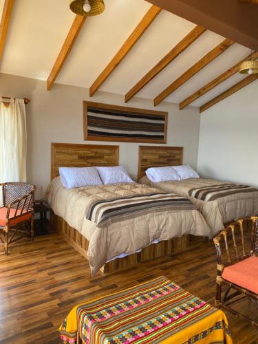 Letto o letti in una camera di Inti Illimani Lodge