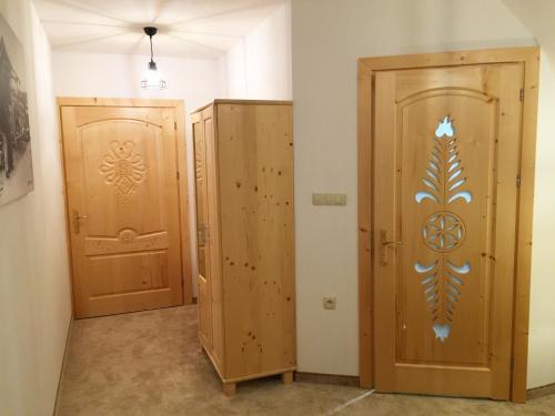 two wooden doors sitting next to each other in a room at Rezydencja Kojsowka in Witów