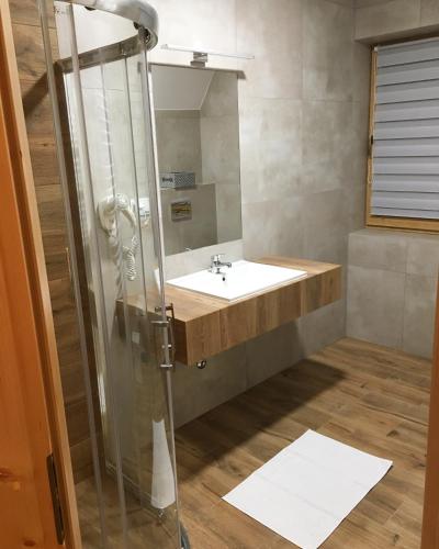 a bathroom with a sink and a shower at Rezydencja Kojsowka in Witów