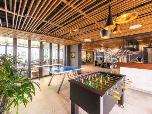 a room with a pool table and ping pong balls at Ibis Saigon Airport in Ho Chi Minh City