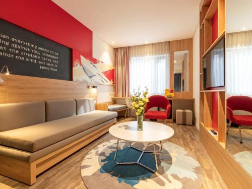 a living room with a couch and a table at Ibis Saigon Airport in Ho Chi Minh City
