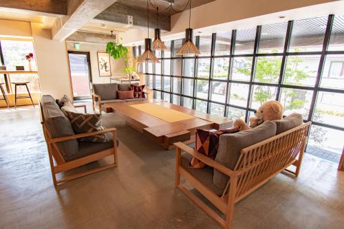 a living room with a wooden table and chairs at The GrandWest Arashiyama in Kyoto